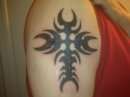 Right arm cross tattoo
