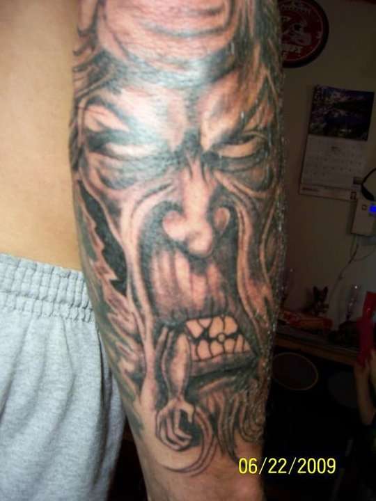 demon eating man tattoo