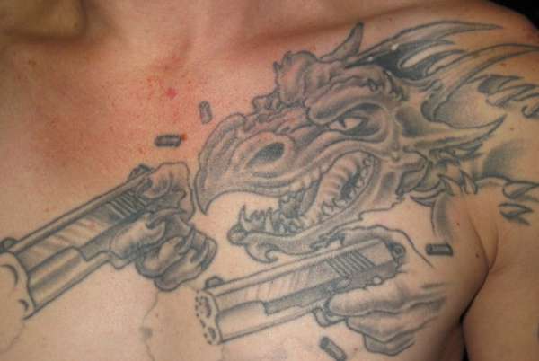 Dragon with guns tattoo