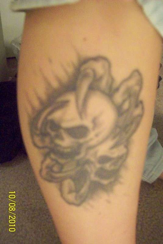 skulls on calf tattoo