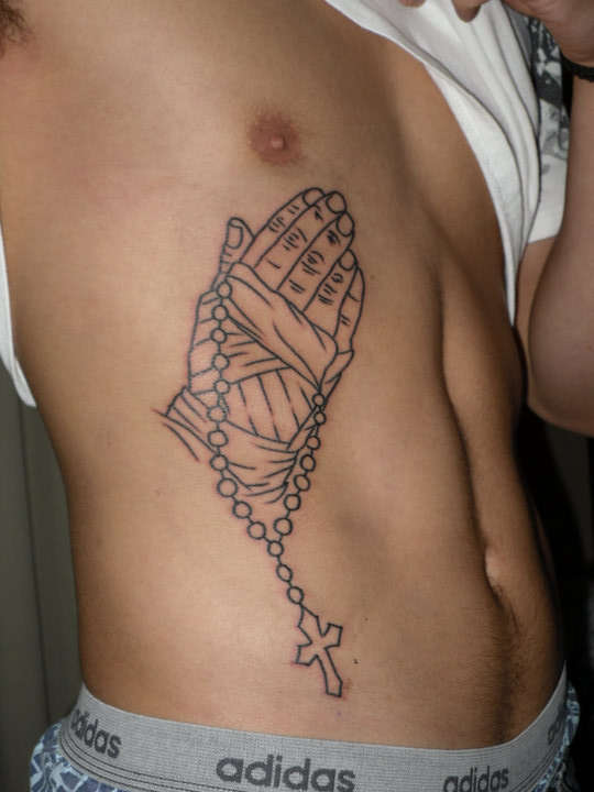 outline of handwraps on praying hands holding a cross tattoo