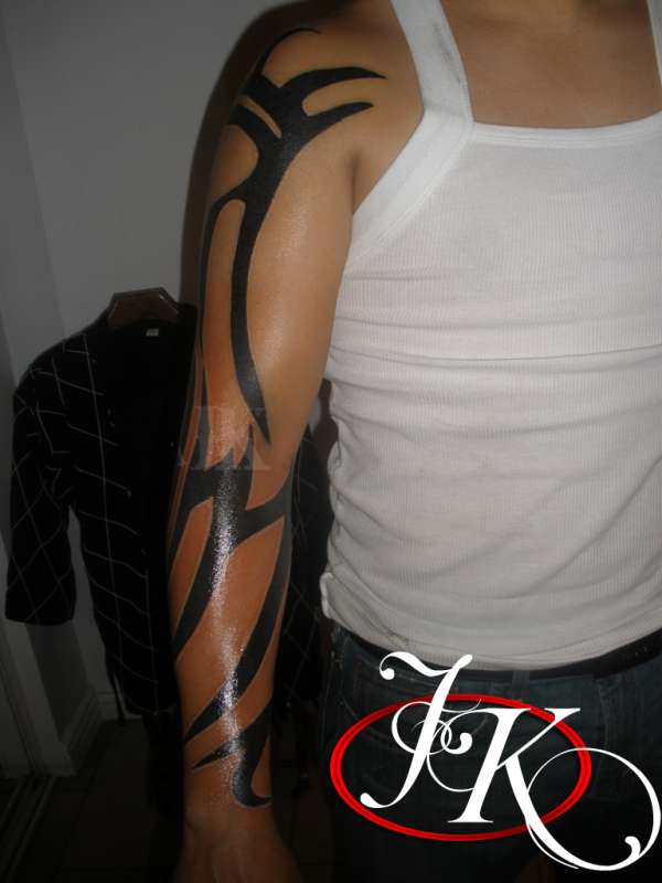 TRADITIONAL TRIBAL SLEEVE TATTOO FRONT VIEW BY JUSTIN KONTRA tattoo