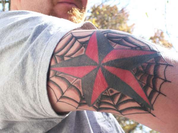 spiderweb with nautical star tattoo