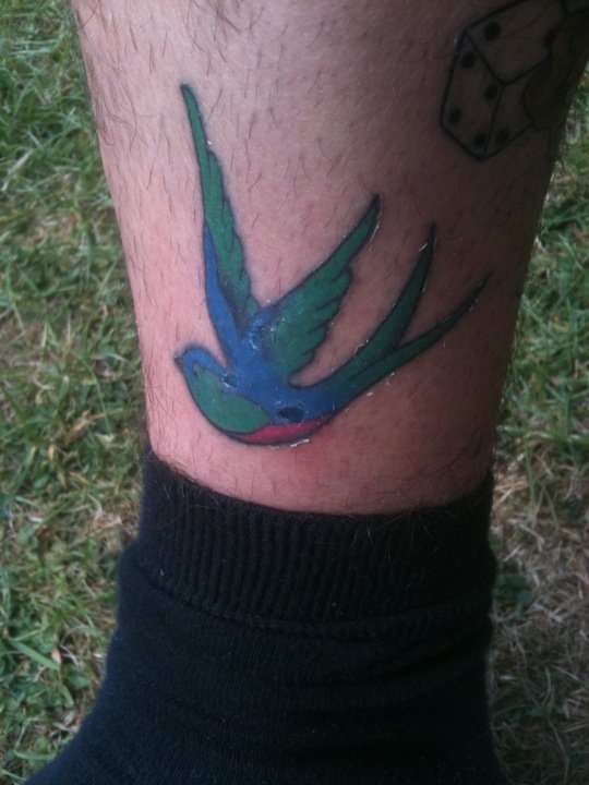 swallow with matching on the other side of leg tattoo