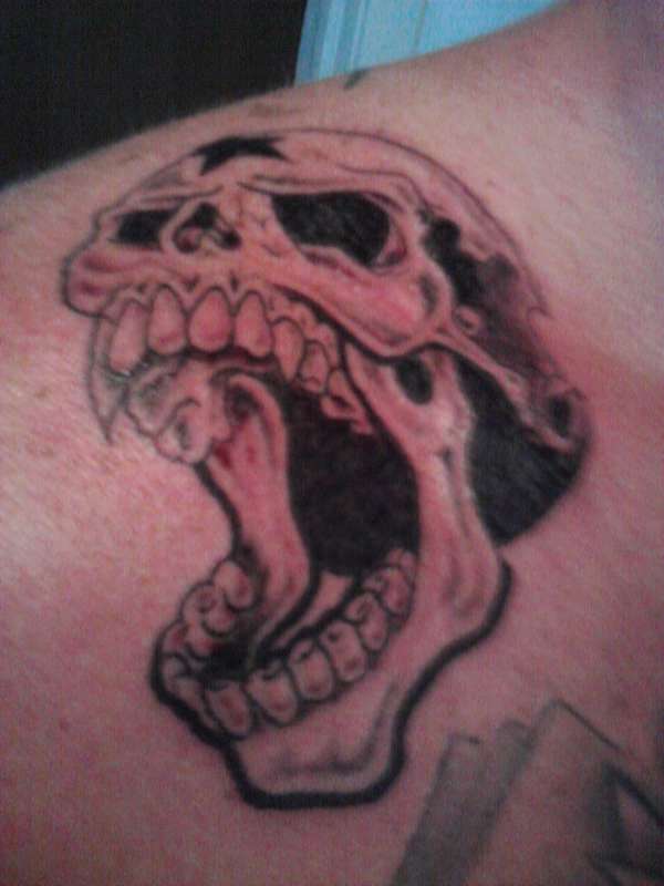 Skull on shoulder tattoo