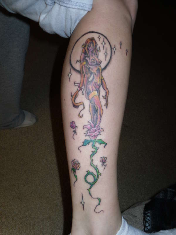 Woman emerging from a rose tattoo