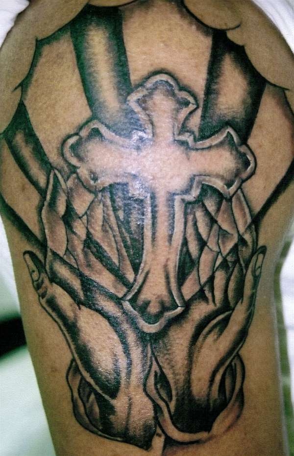 Hands and cross tattoo