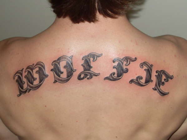 scrollwork lettering tattoo