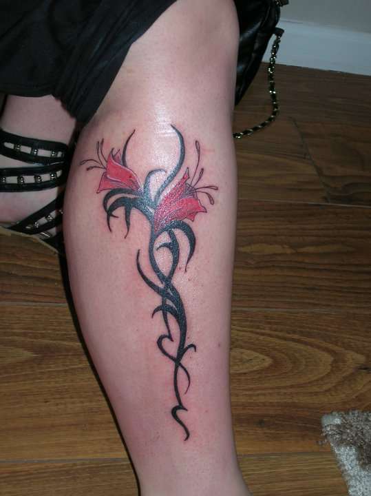 tribal/flower leg piece tattoo