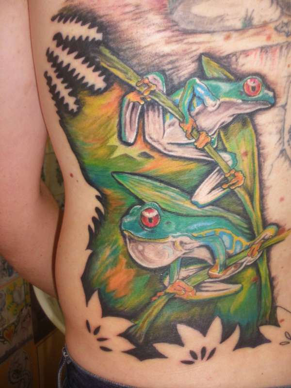 two little frogs in his piquitos back tattoo
