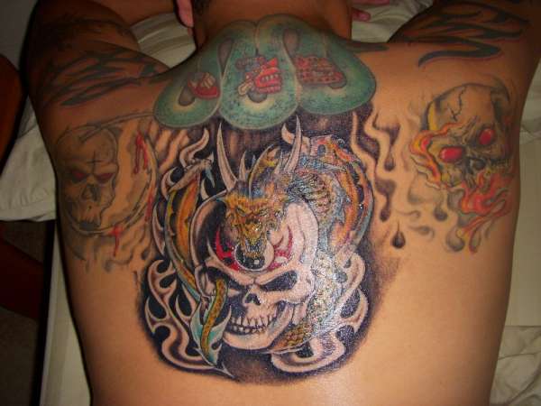 Demon skulls and aztec serpent tattoo