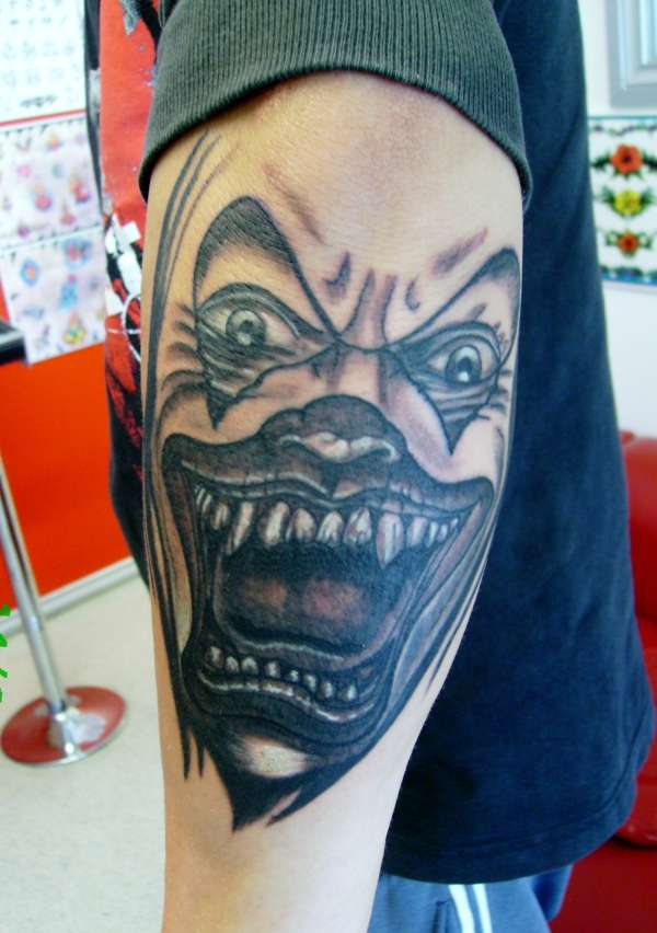 crazy evil clown grey wash mens arm tattoo