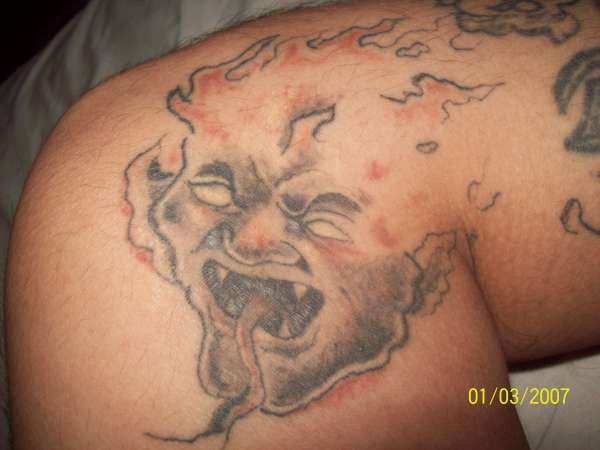 demon on leg tattoo
