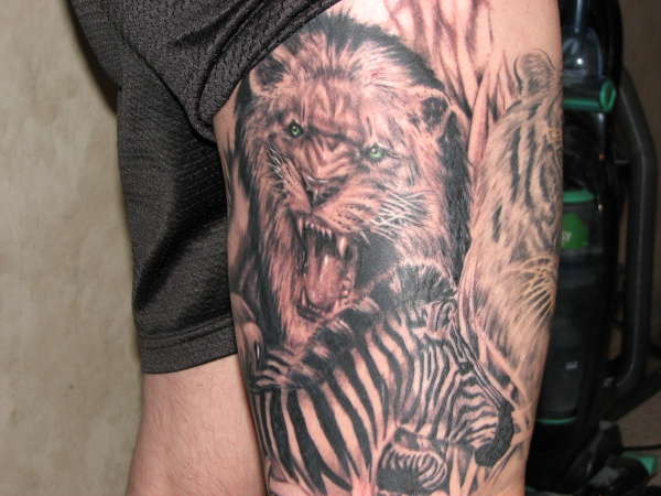 lion and zebra Done by Ron Antonick, Gen X tattoo