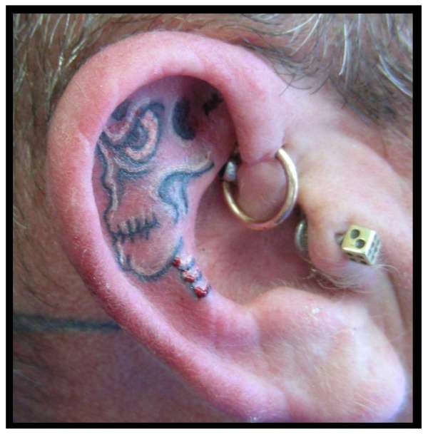skull ear tattoo