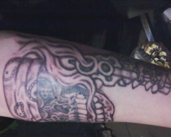 thuged out skull with revolver tattoo