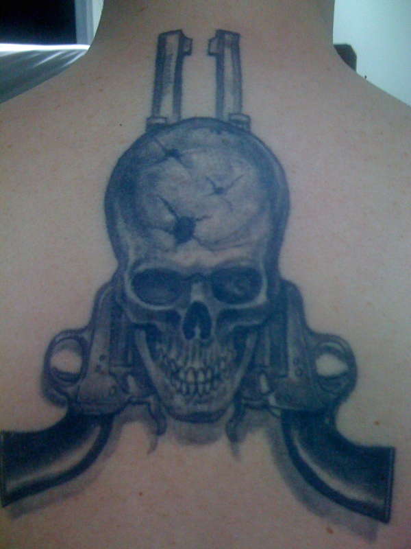 Skull and guns tattoo