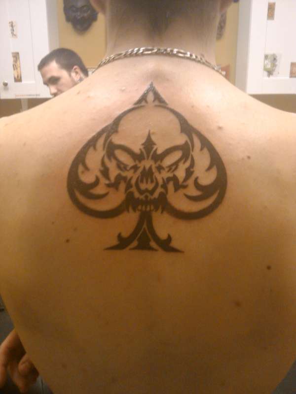 Tribal ace with skull tattoo