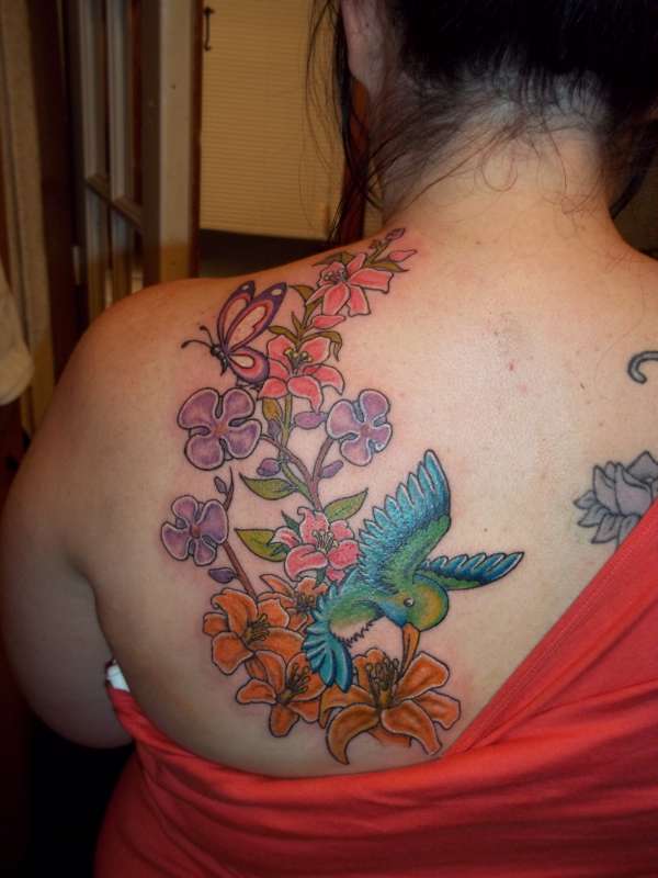 Hummingbird lillies butterfly and orchids tattoo