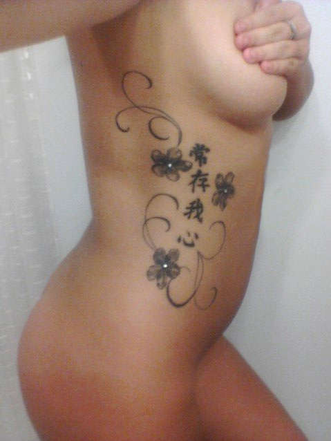 flowers on ribs tattoo