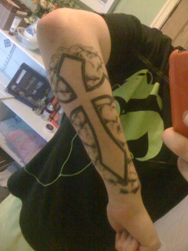 Cross on forearm tattoo