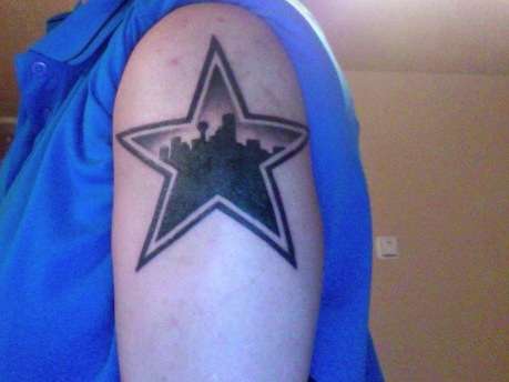 Dallas Star with Skyline tattoo