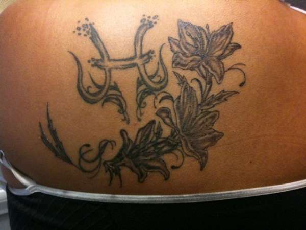Horoscope and flowers tattoo