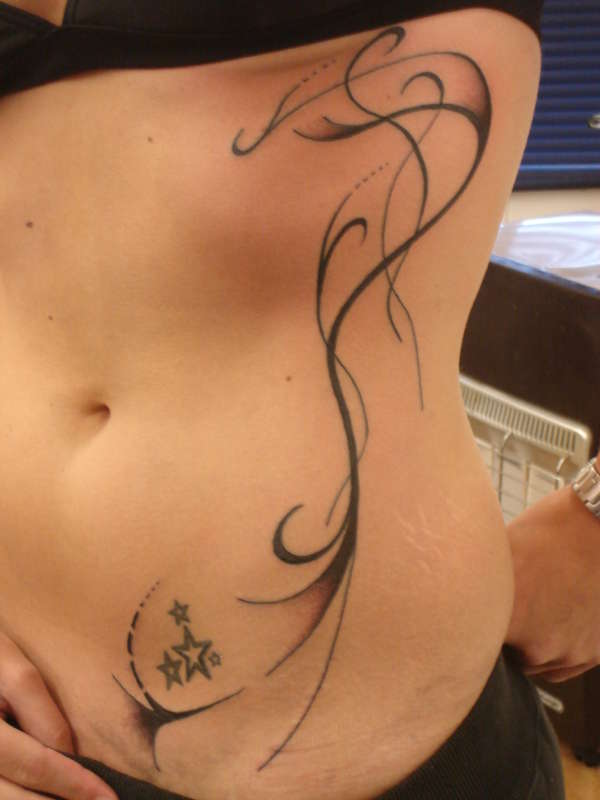 simple tribal rib design tattoo