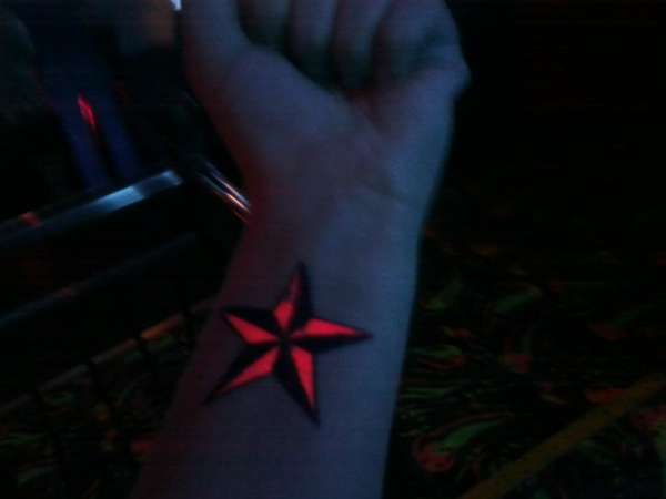 Pink UV star tattoo