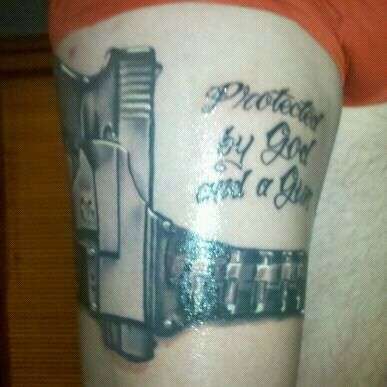Protected By God And A Gun tattoo