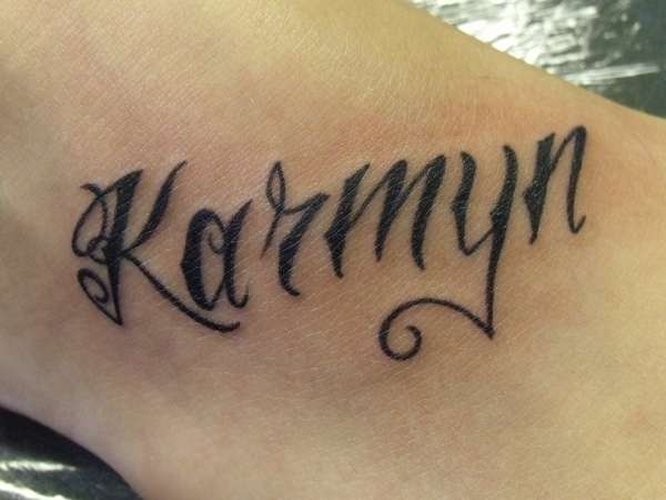 lettering on foot tattoo