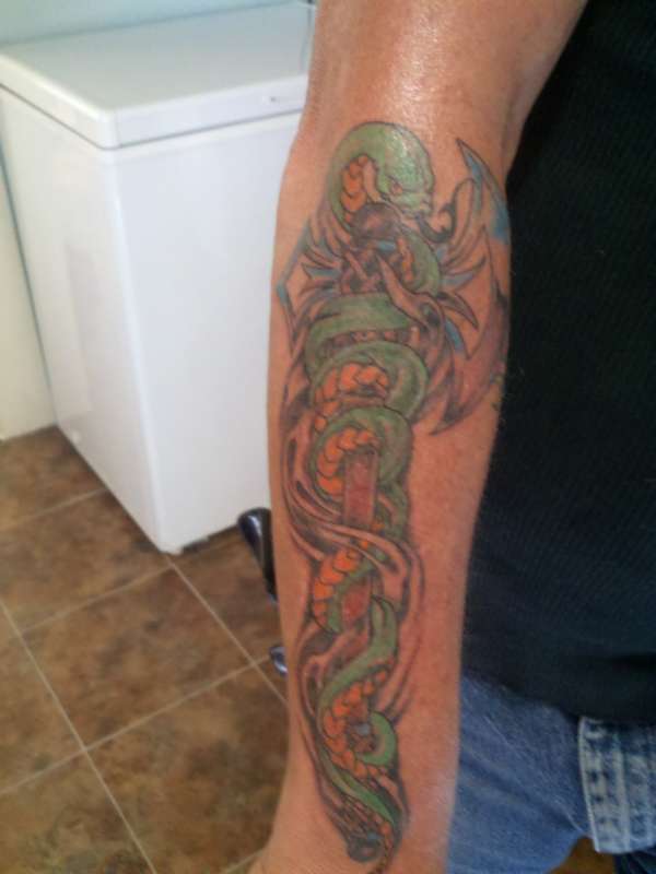 Snake and axe tattoo