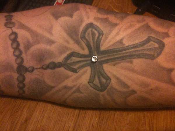 cross with dermal tattoo