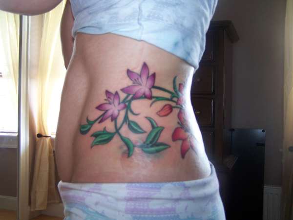 side vines and flowers tattoo