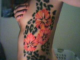 Flowers and leopard print tattoo