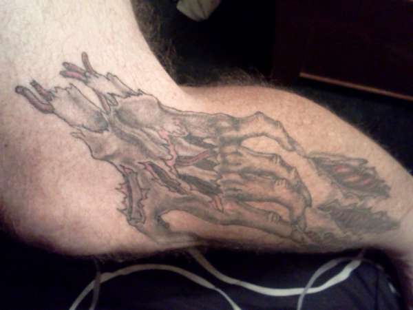 severed hand tearing skin tattoo