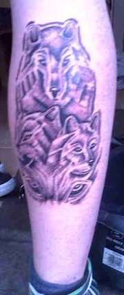 wolves on leg tattoo