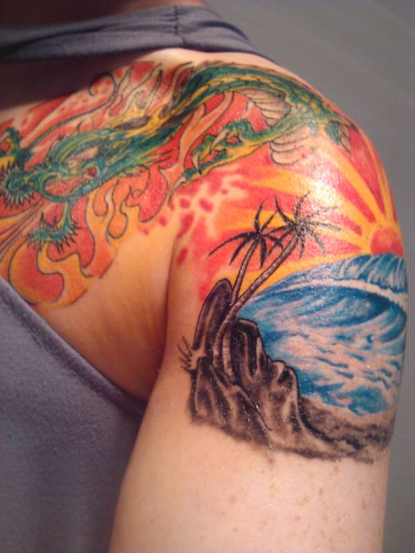 fire dragon rising from sunset tattoo