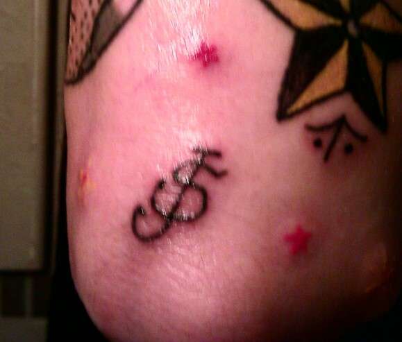 Sailor Jerry logo tattoo on elbow tattoo