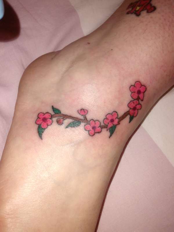 small blossom on ankle tattoo