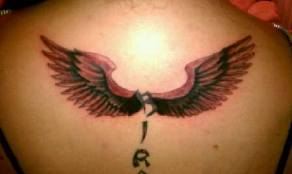 Letters and wings tattoo