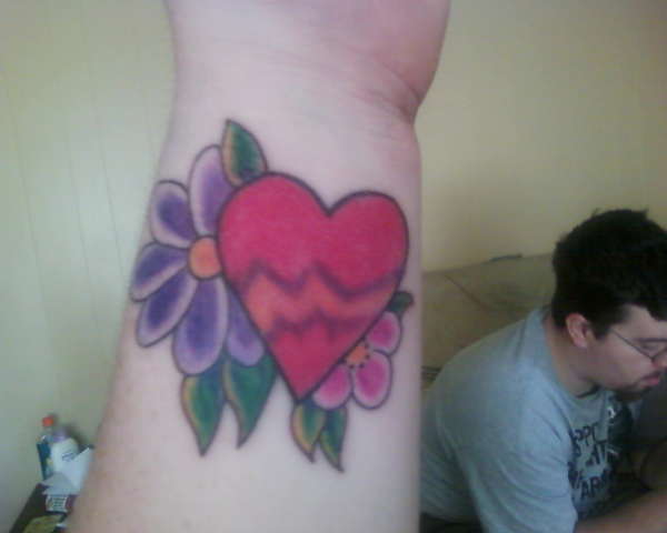 Wrist tattoo with heart and flowers tattoo