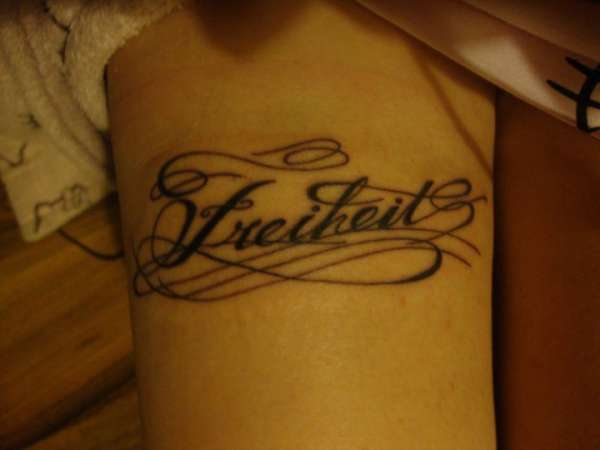 'freiheit' lettering tattoo