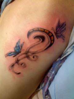 Butterflies and swirls tattoo