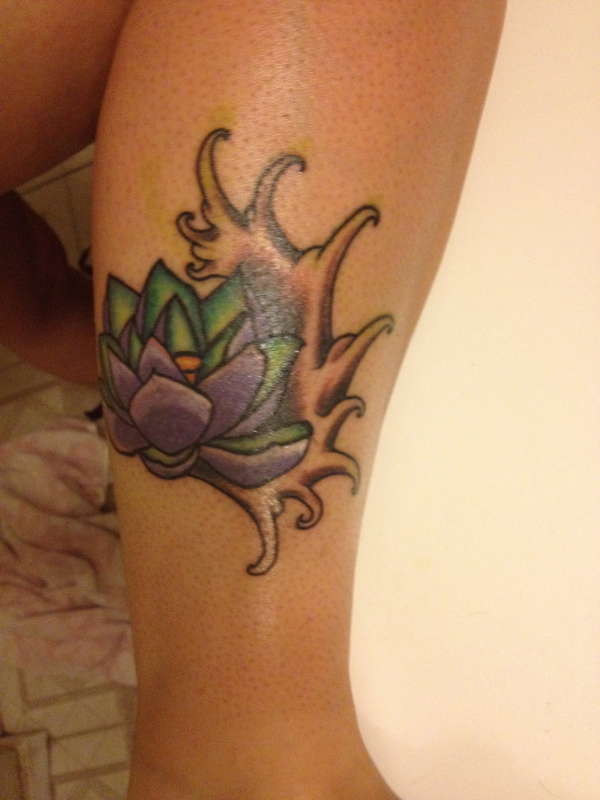 Lotus flower on a wave tattoo