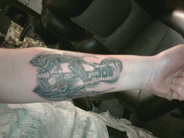 Dragon coiled around guitar tattoo