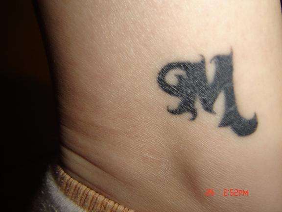 "M" tattoo