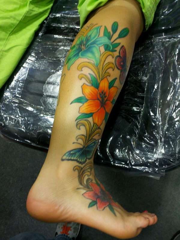 Lily flowers and butterfly tattoo