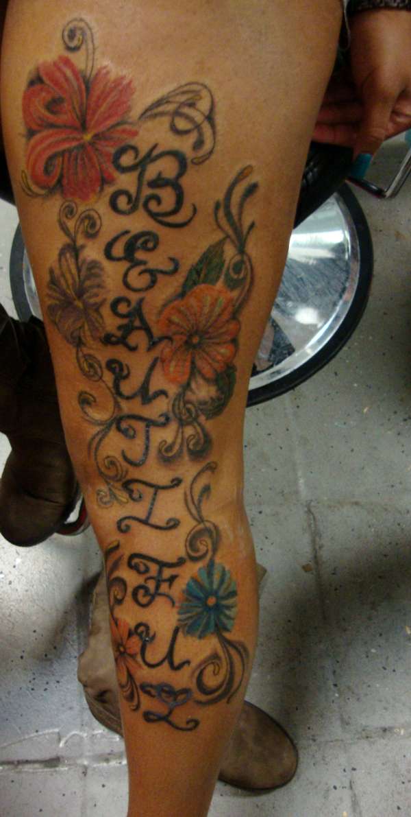 beautiful script w flowers tattoo