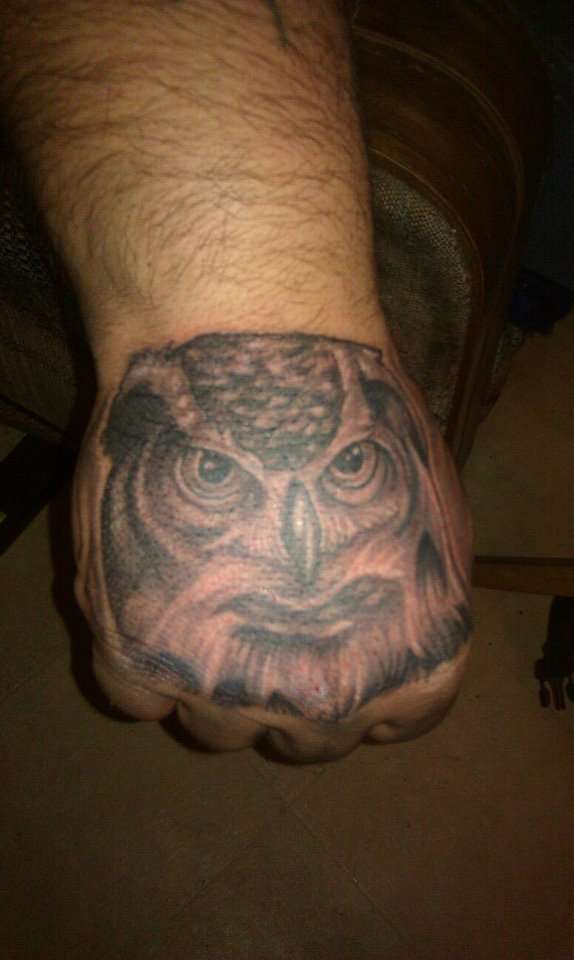 black and gray owl fist tattoo